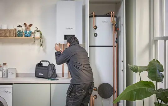 Gas Safe engineer fitting a new Vaillant boiler in a London home